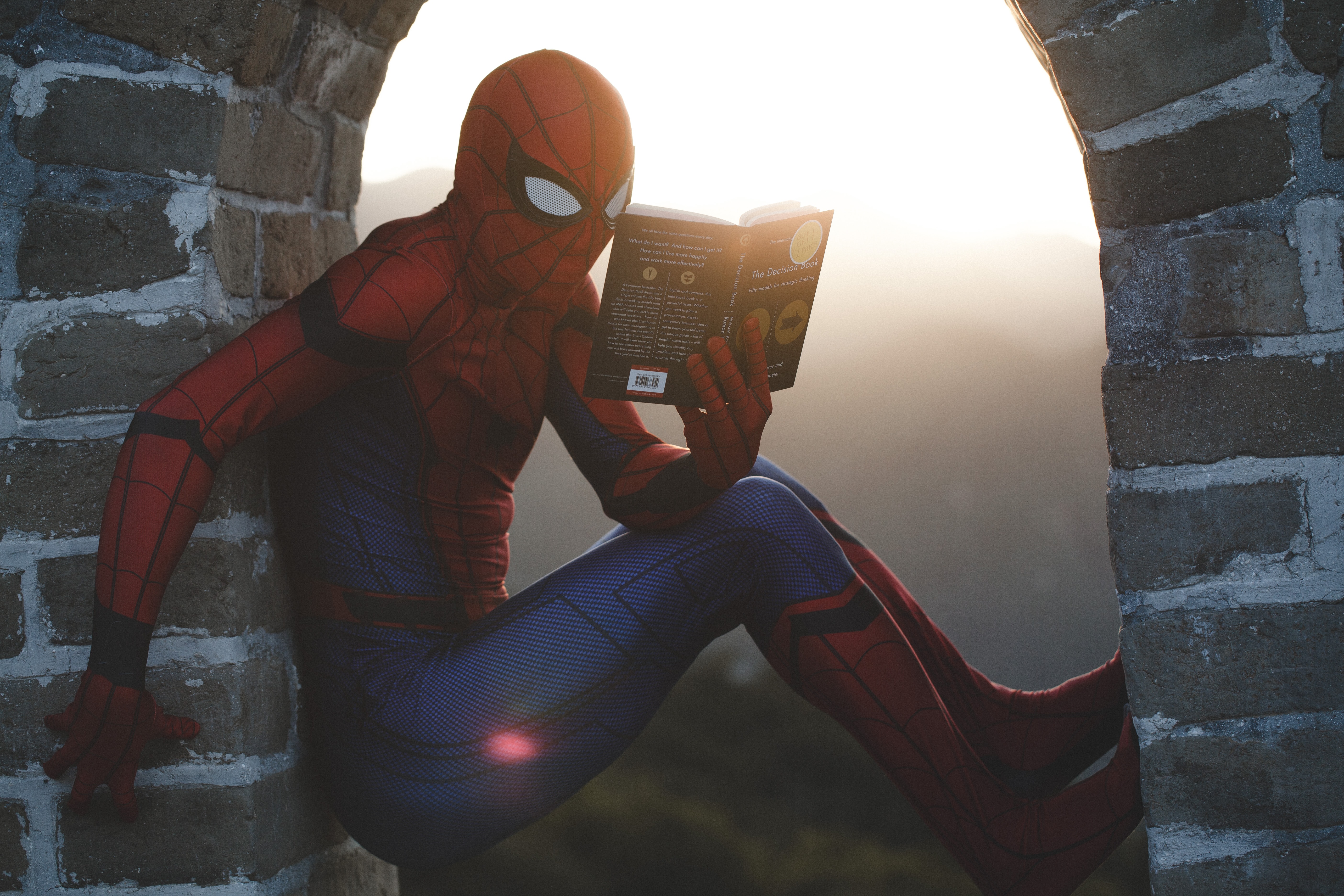 Spiderman reading outdoors
